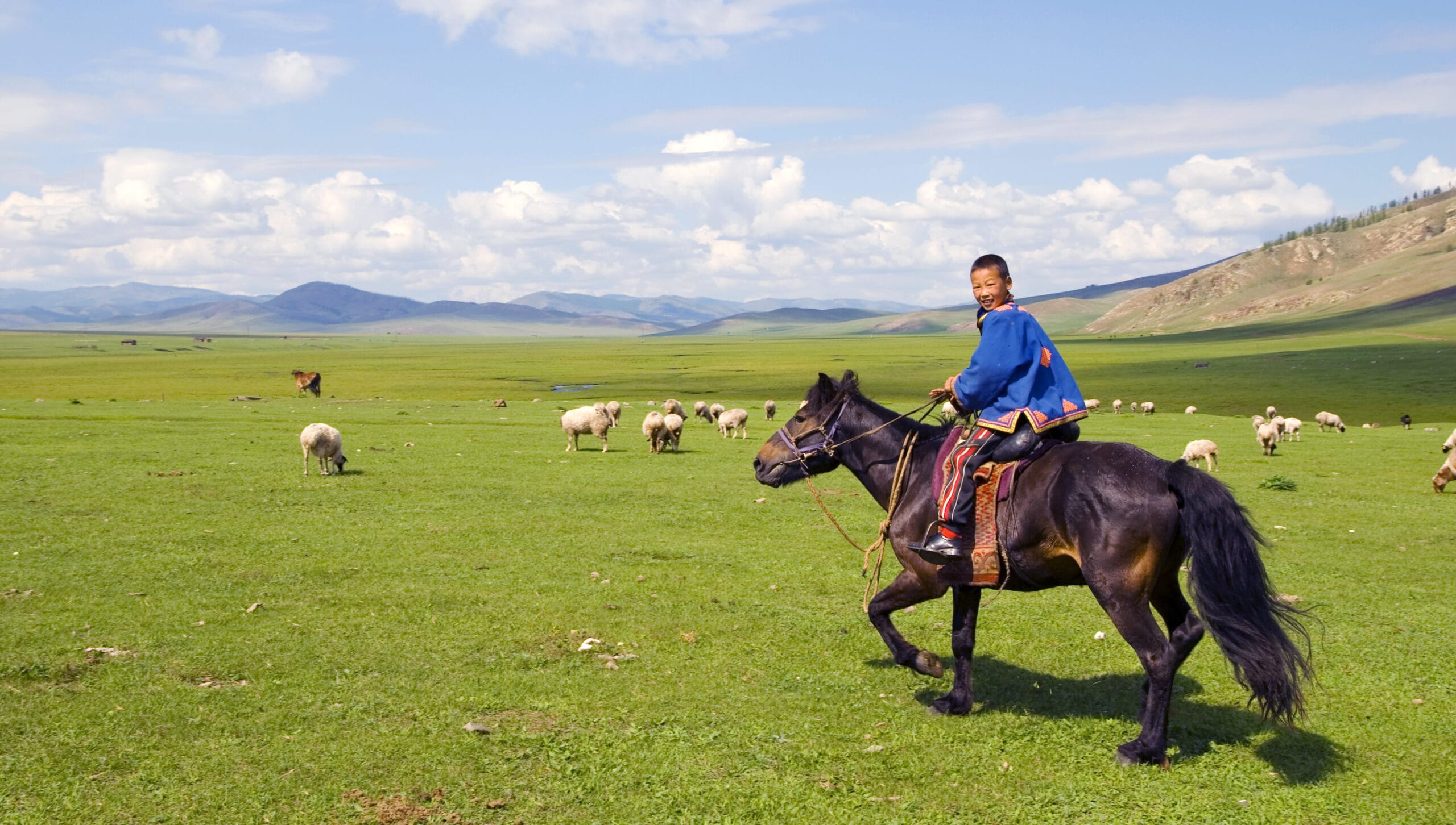 Boy Riding A Horse In A Beautiful Scenic View Of Nature